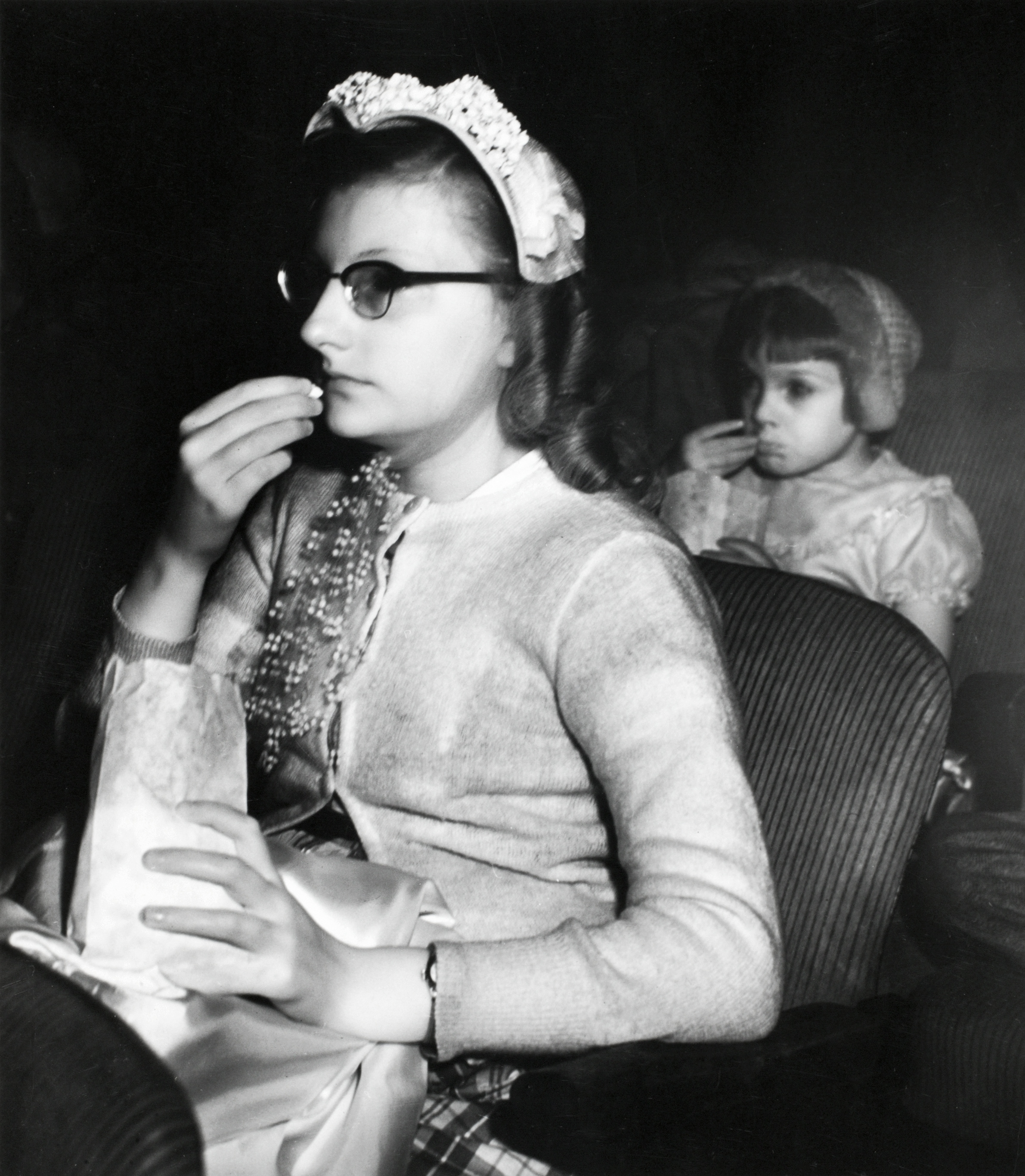 TRANSFIXED: Girl eating popcorn, ca. 1943. © Weegee/ International Center of Photography.