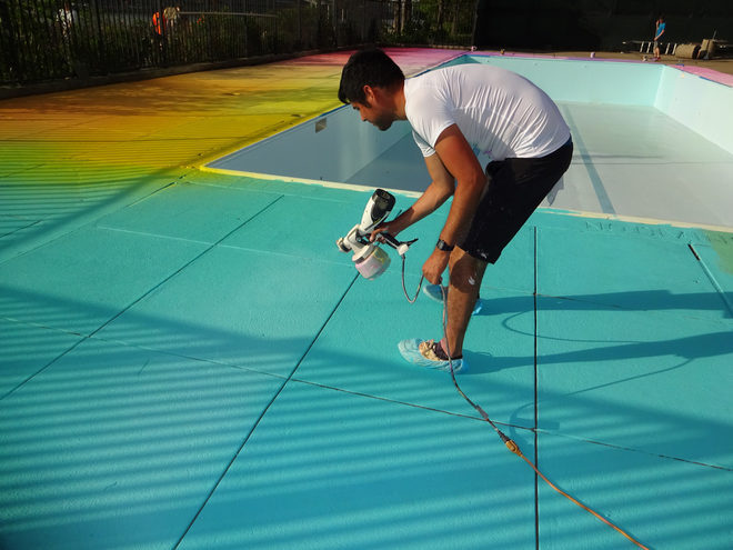 LIFE IN COLOR...Eric Rieger at work painting the rainbow deck