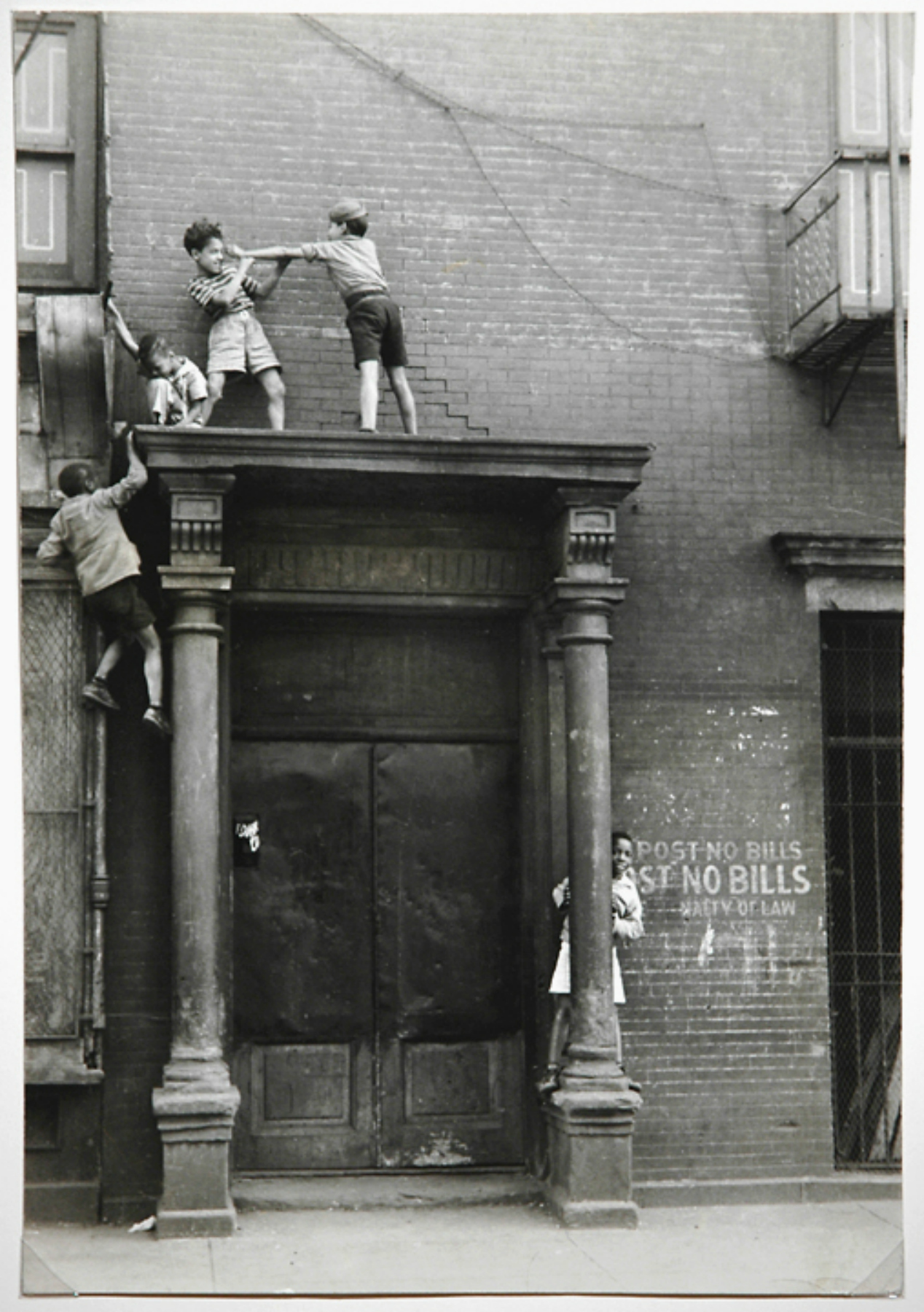 CHILD'S PLAY...Helen Levitt captures kids climbing on to a doorway